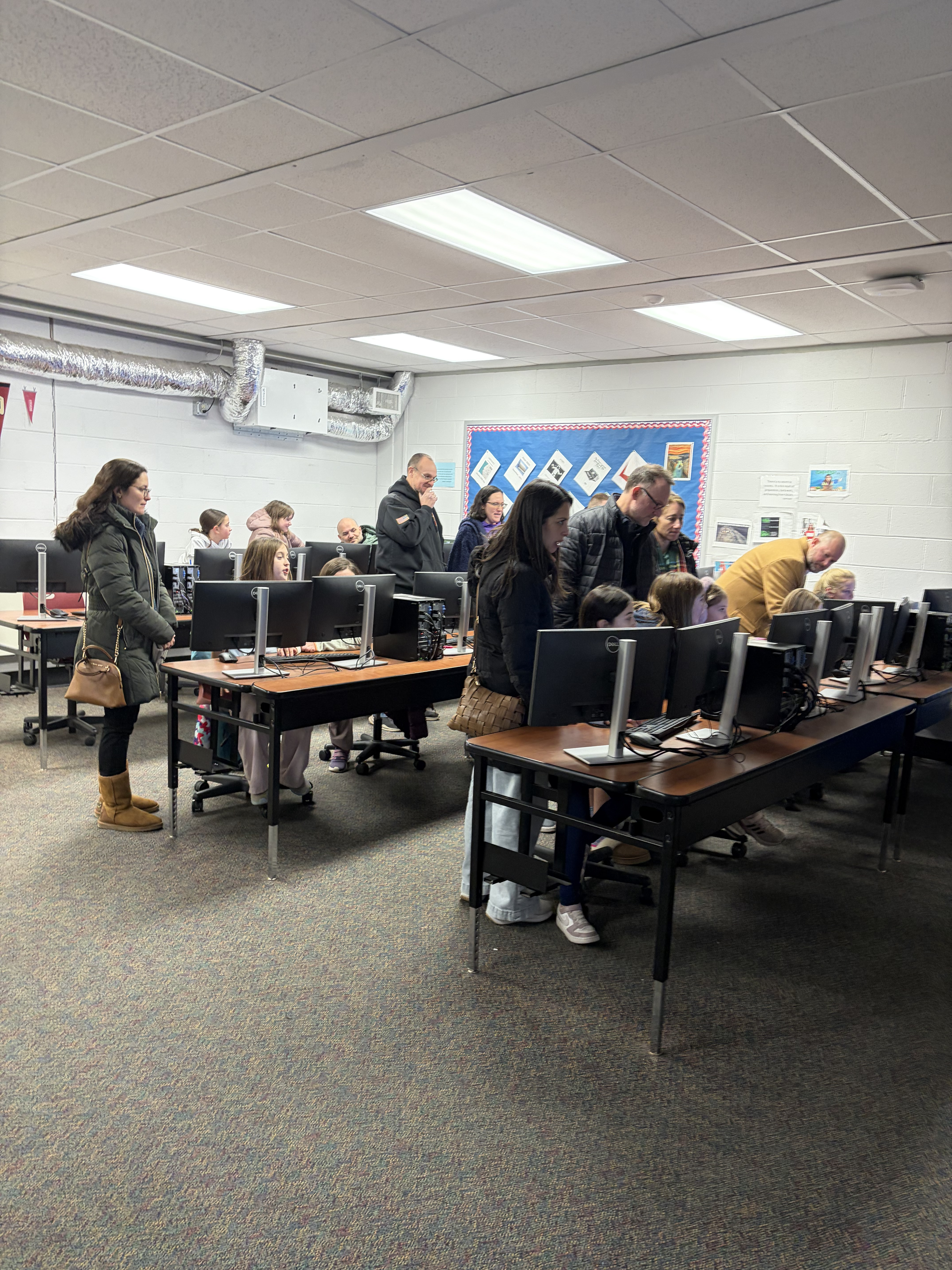 Parents viewing students' Scratch projects at the showcase