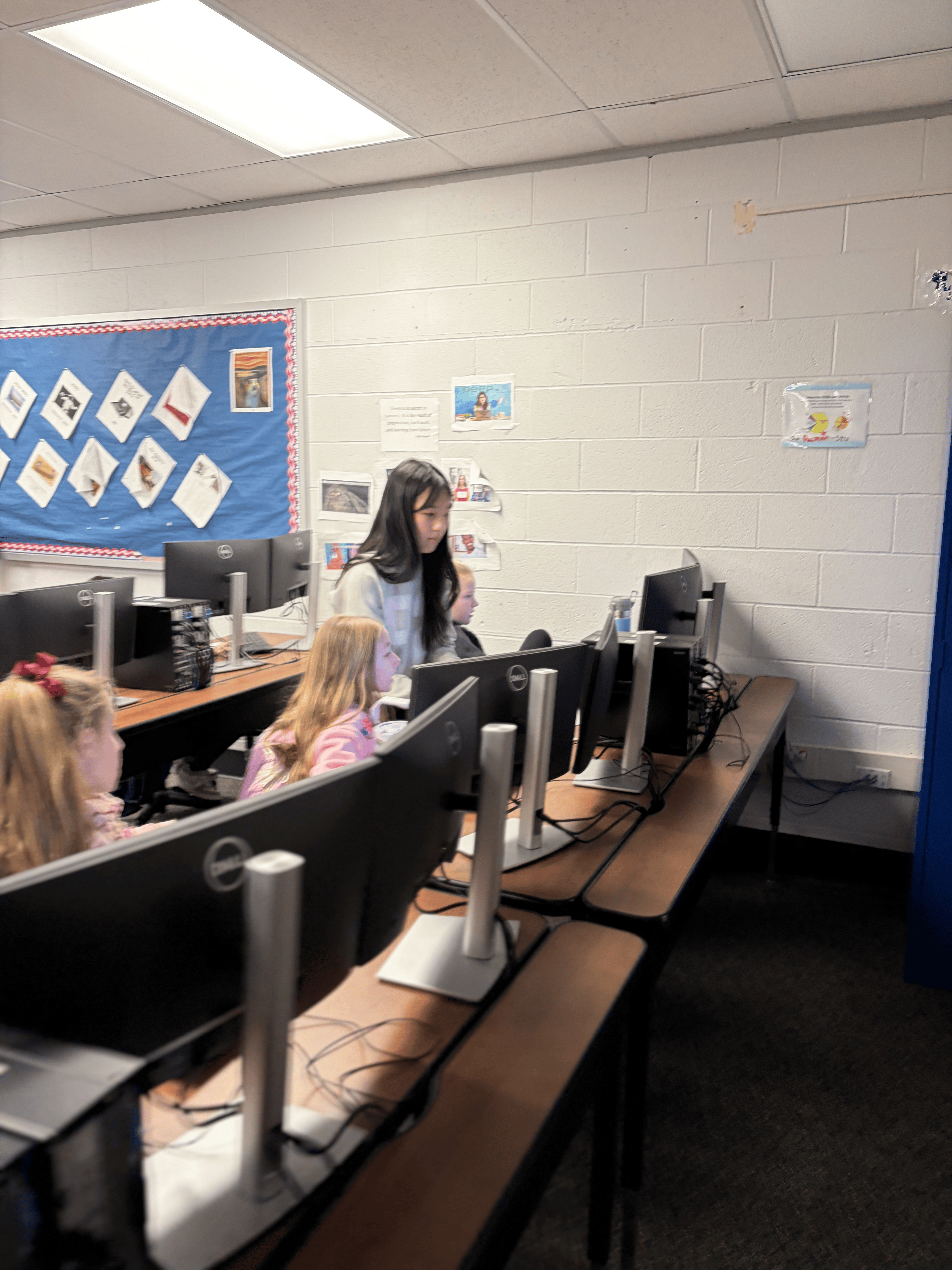 Students coding on Scratch in the computer lab