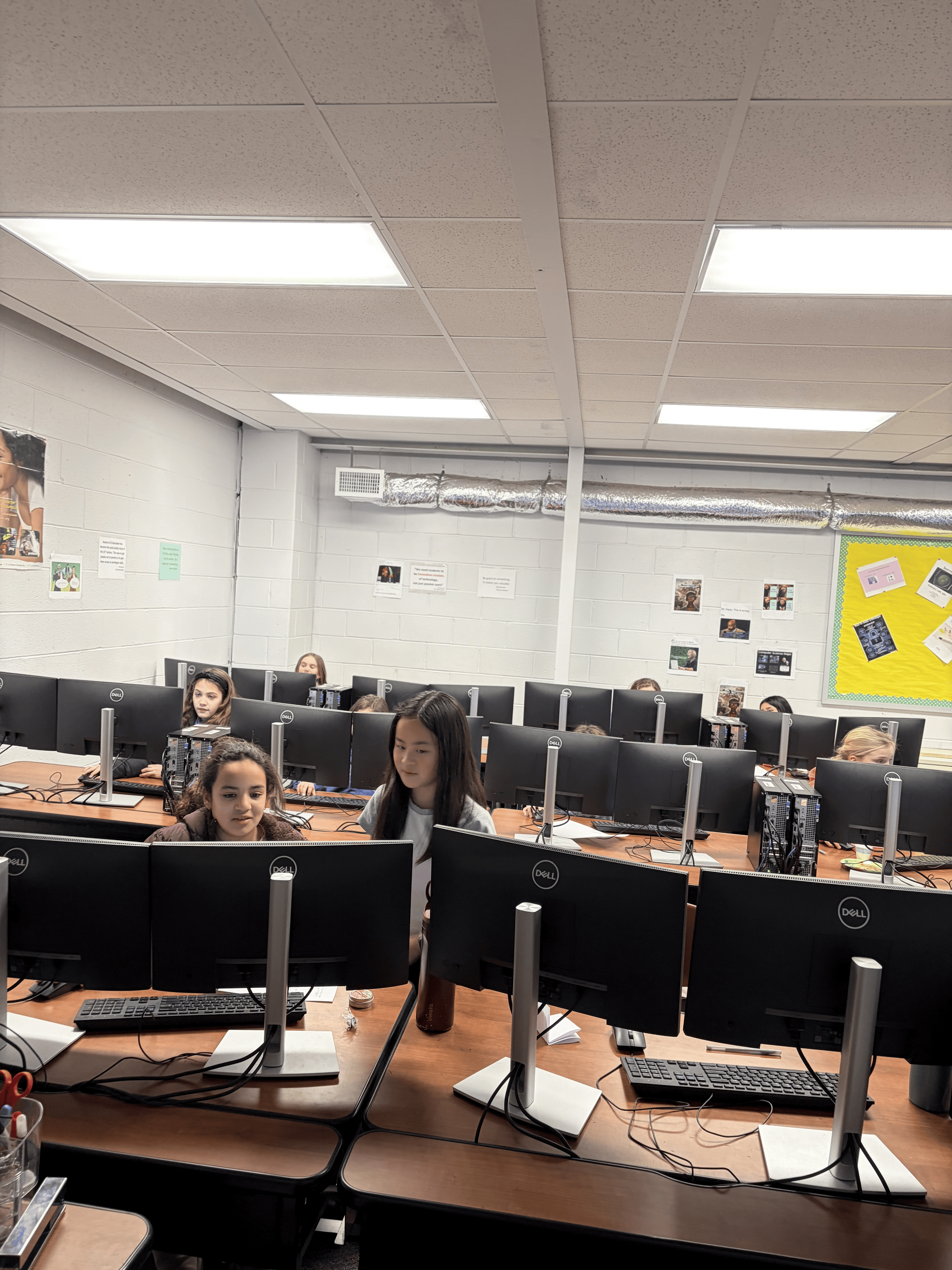 Girls focused on their Scratch projects