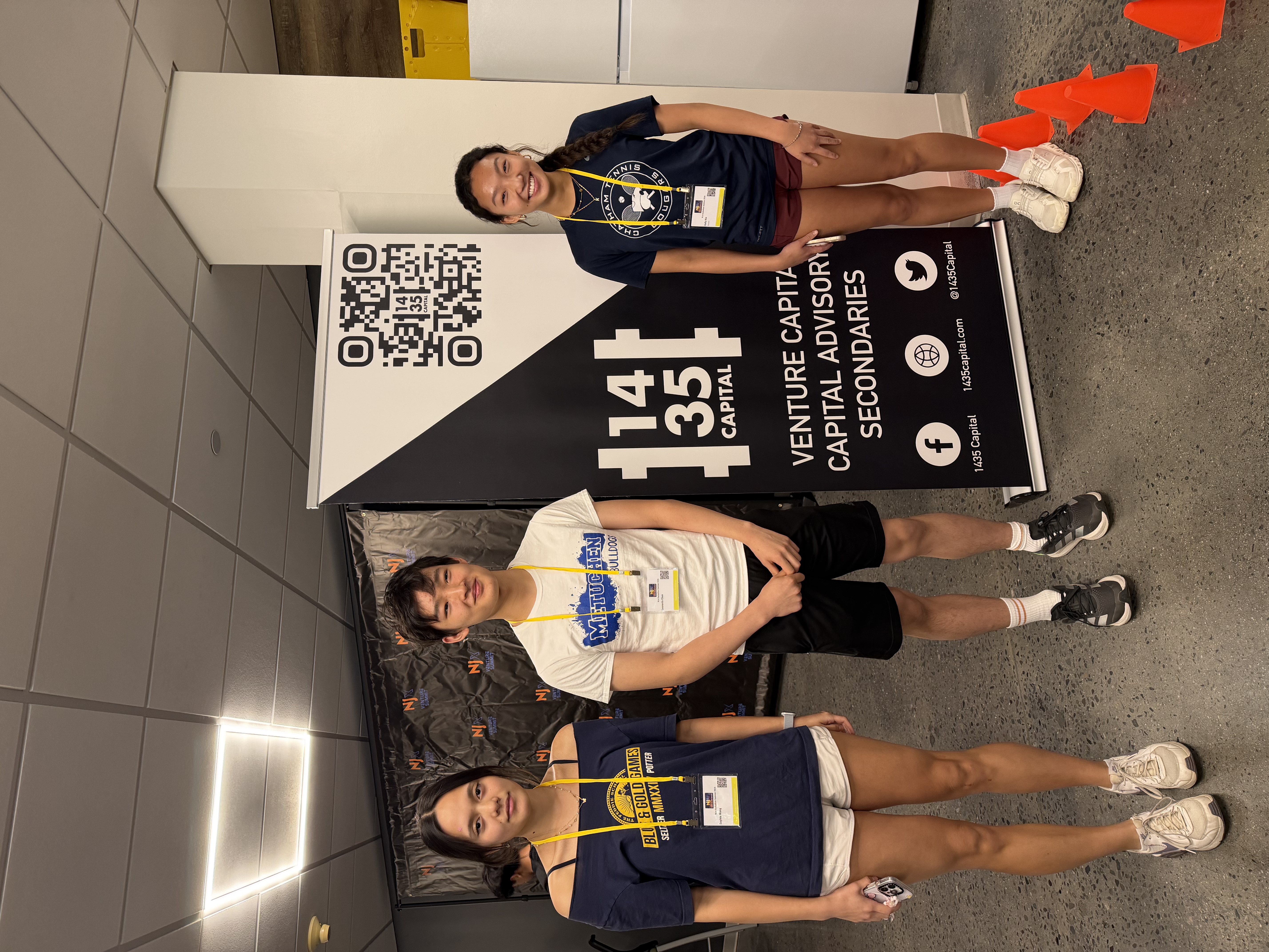 Team in front of 1435 Capital banner